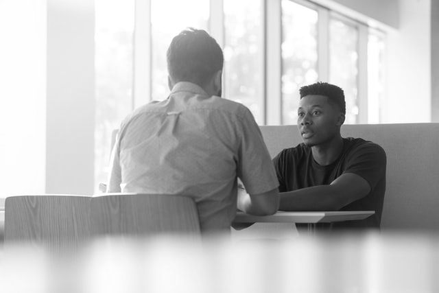 PALS Advisor seated at a table helping a client